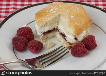 Raspberry cream scone on a plate in close-up