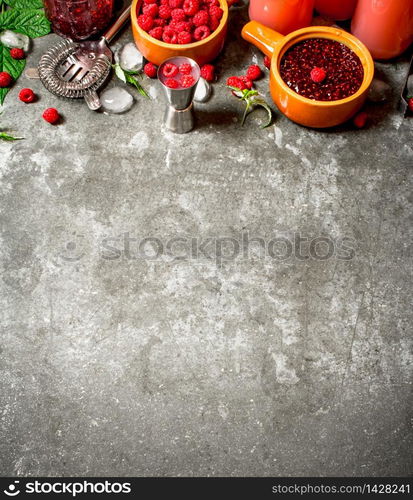 Raspberry jam with berries and ice. On the stone table.. Raspberry jam with berries and ice.