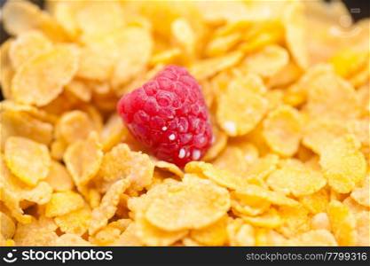raspberry,milk and flakes in a bowl