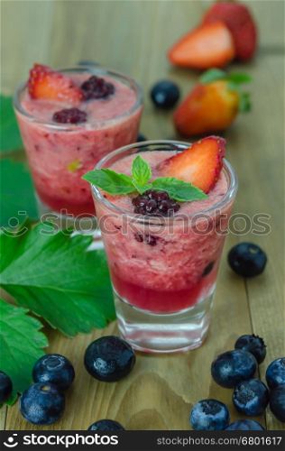 Raspberry smoothie with fresh berries. Raspberry smoothie with fresh berries on a wooden table