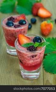 Raspberry smoothie with fresh berries. Raspberry smoothie with fresh berries on a wooden table