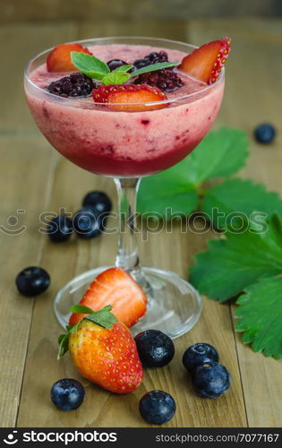 Raspberry smoothie with fresh berries. Raspberry smoothie with fresh berries on a wooden table