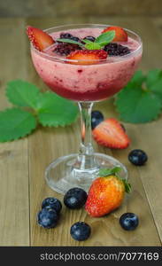 Raspberry smoothie with fresh berries. Raspberry smoothie with fresh berries on a wooden table