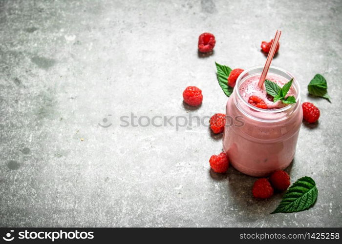 Raspberry smoothie with mint. On a stone background.. Raspberry smoothie with mint.