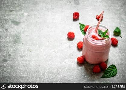 Raspberry smoothie with mint. On a stone background.. Raspberry smoothie with mint.