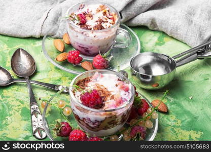 Raspberry sundae in mug. ice cream with raspberry and spoon for ice cream