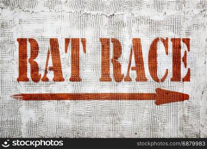 rat race - career and competition concept - graffiti sign on stucco wall