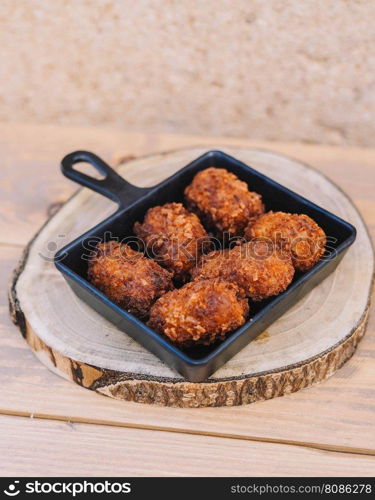 Ration of typical Spanish croquettes stuffed with chicken and seafood