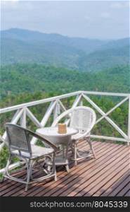 rattan chair on balcony with beautiful mountain view