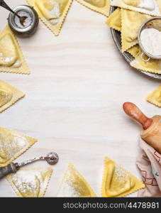 ravioli triangoli making, preparation on white wooden background, top view, frame. Italian food concept.