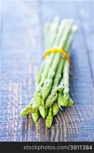raw asparagus on the wooden table, green asparagus