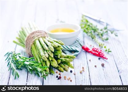 raw asparagus with salt and aroma spice on a table