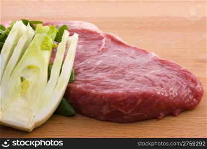 Raw beef and fennel. photo of a raw beef with a fresh fennel