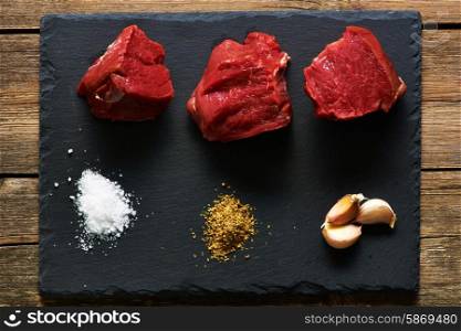 Raw beef filet mignon meat over slate