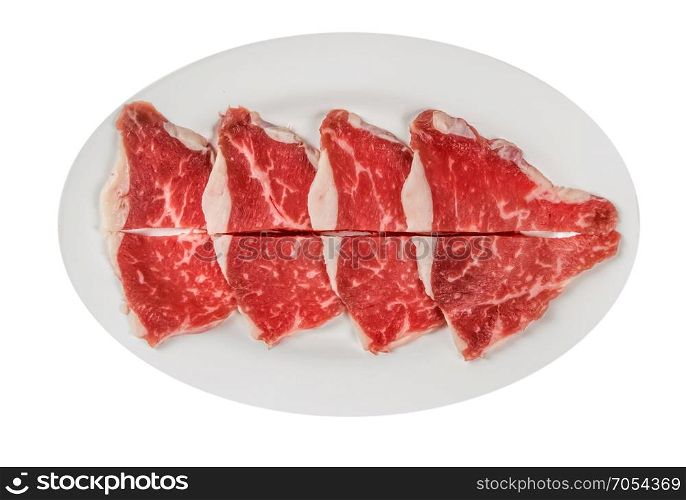 raw beef fillets on a plate . Top view of some raw beef fillets on a plate with white background