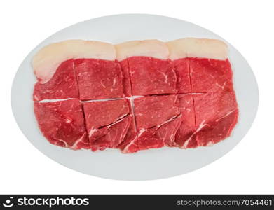 raw beef fillets on a plate . Top view of some raw beef fillets on a plate with white background