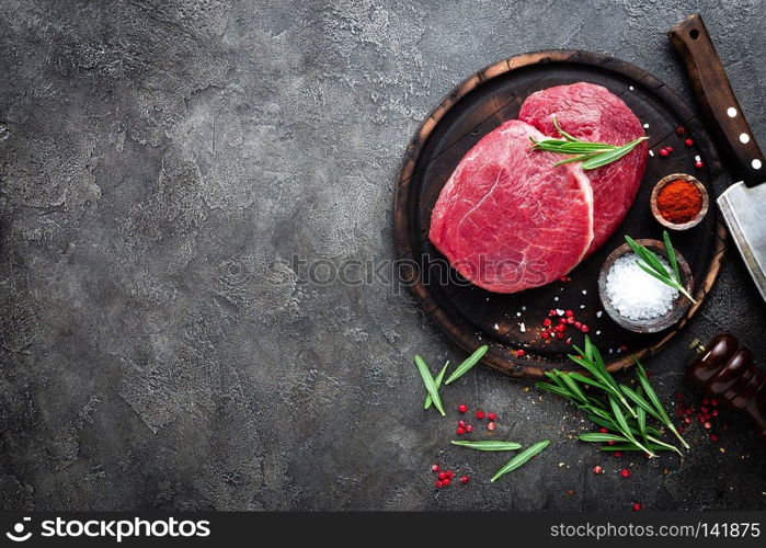 Raw beef meat. Fresh cut of beef meat on board with spices