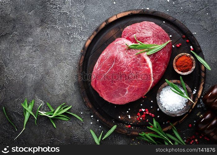Raw beef meat. Fresh cut of beef meat on board with spices