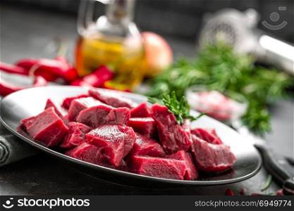 Raw beef meat sliced on black background