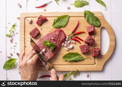 Raw beef on white wood background