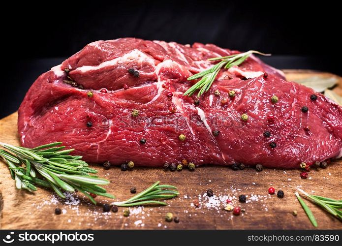 raw beef steak cut in half on brown kraft paper, close up