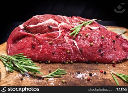 raw beef steak cut in half on brown kraft paper, close up