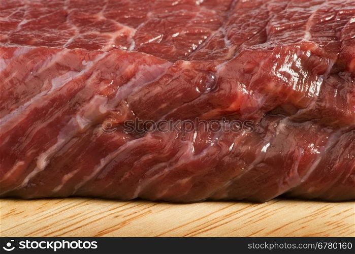 Raw beef steak meat on kitchen board close up