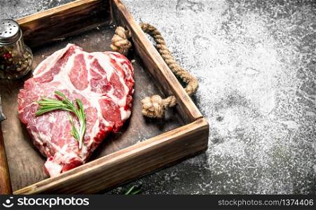 Raw beef steak on an old tray. On rustic background.. Raw beef steak on an old tray.