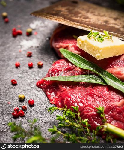 Raw beef Steak with fresh herbs,spices, butter and old cleaver