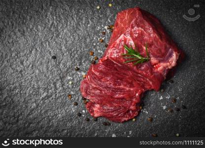 Raw beef steak with herb and spices / Fresh meat beef sliced on black background