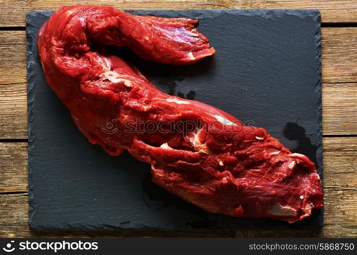 Raw beef tenderloin meat over slate