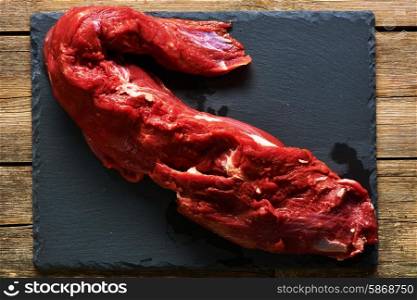 Raw beef tenderloin meat over slate