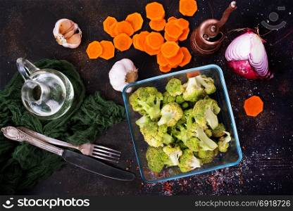 raw broccoli and raw carrot on a table