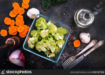 raw broccoli and raw carrot on a table