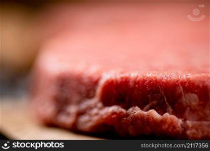 Raw burger. Macro background. The texture of the raw burger. High quality photo. Raw burger. Macro background. The texture of the raw burger.