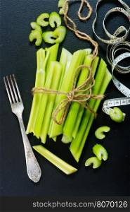 raw celery on black table, fresh celery