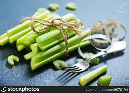 raw celery on black table, fresh celery