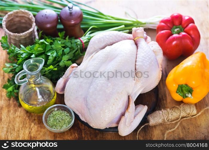 raw chicken and vegetables on a table