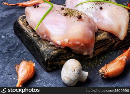 raw chicken breast. chicken raw fillets on kitchen plate with spices and mushrooms