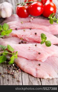 raw chicken breast fillets with herbs and vegetables