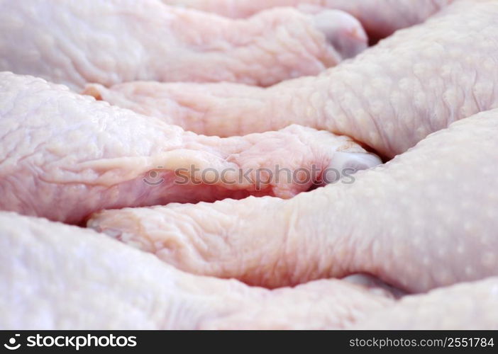 Raw chicken drumsticks in a supermarket package