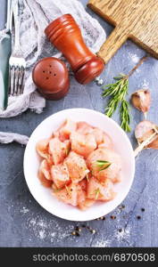 raw chicken fillet in white bowl and on a table