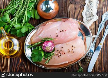 raw chicken fillet with spice and on a table