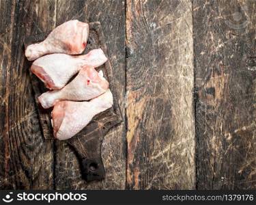 Raw chicken legs on cutting Board. On wooden background.. Raw chicken legs on cutting Board.