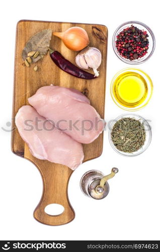 Raw chicken meat fillet on cutting board. Studio Photo. Raw chicken meat fillet on cutting board