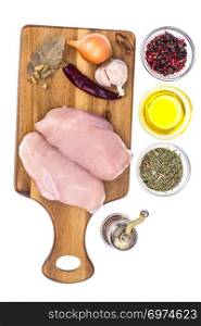 Raw chicken meat fillet on cutting board. Studio Photo. Raw chicken meat fillet on cutting board