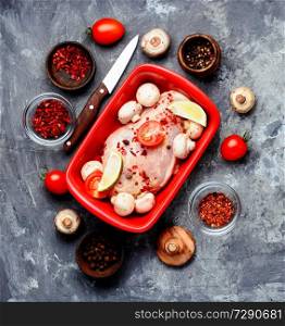 Raw chicken meat with mushrooms in a baking dish.Ingredients for cooking. Raw chicken in baking dish