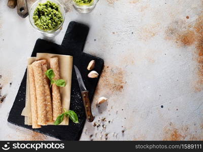 raw chicken sausages on black stone board