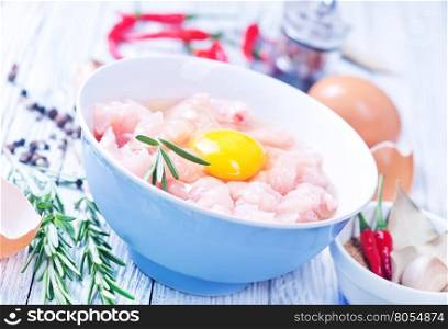 raw chicken with salt and spice in the bowl