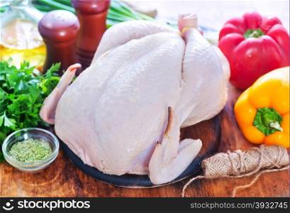 raw chicken with spice and raw vegetables